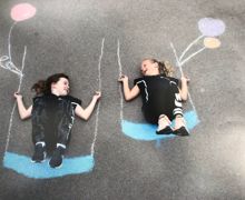 Children swinging on chalk swing